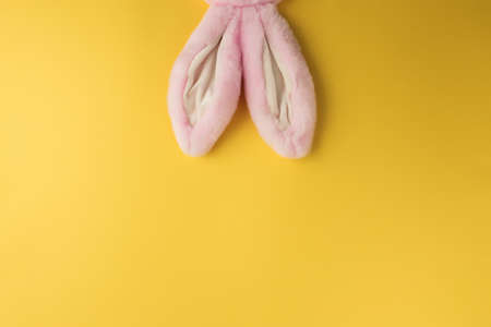 Pink Easter bunny ears on the yellow backgroundの写真素材