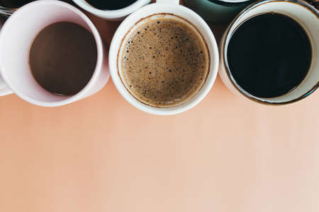 Multiple coffee cups on the beige background. High quality photoの写真素材