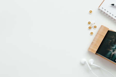 Office work, education flat lay concept with phone, headphones on the white background. High quality photoの写真素材