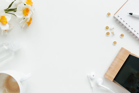 Office work, education flat lay concept with clips, phone, earphones, cup of coffee, pencil and...