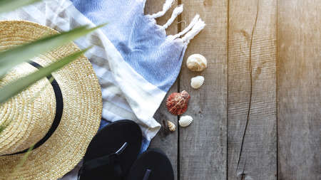 Travel, vacation, weekends concept. Straw hat, palm leaf, shoes, towel, shellsの写真素材