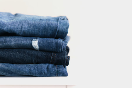 A stack of blue denim jeans or pants. Textile industry concept. Clothing concept stores. Sale concept. High quality photoの写真素材