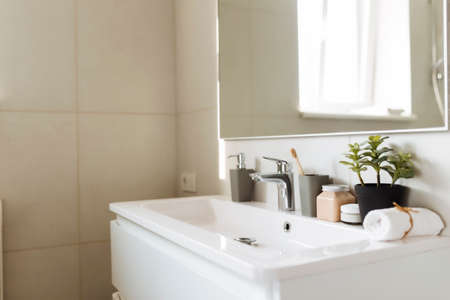 Washbasin in white bathroom with bath accessories. Hotel cleaning concept. Household concept. High quality photoの写真素材