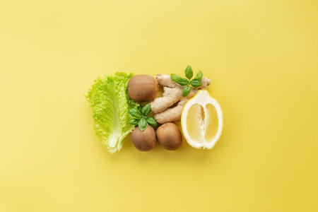 Healthy and organic food flay lay concept on yellow background. A square made of different...