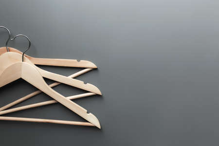 Black Friday or clothing industry concept on gray background flat lay with straight folded wooden clothes hangersの写真素材