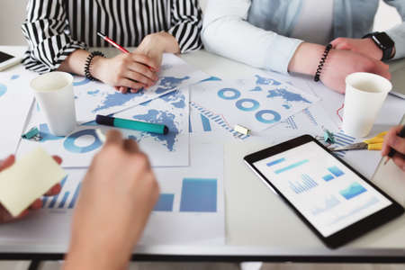Business planning, colleagues sitting at table with different graphics, chartsの写真素材