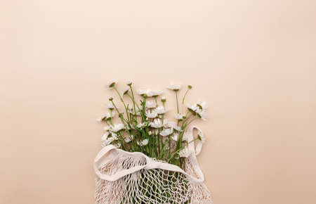 Eco friendly summer concept on beige background with eco shopping bag, flowersの写真素材