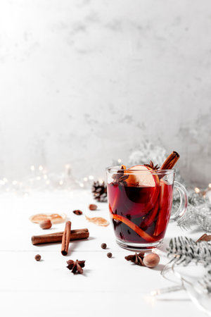 Christmas time. Glass cup of Mulled Wine on white gray concrete background tableの写真素材