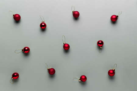 Pattern on gray background with small red Christmas balls, sphere fir tree toysの写真素材