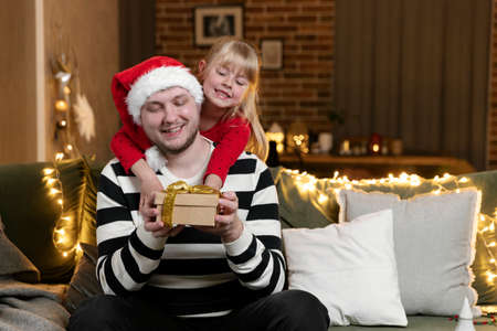 Merry Christmas and Happy New Year. Christmas gift surprise. Father and daughterの写真素材