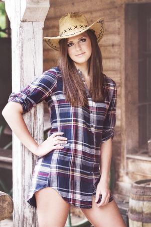 Cowgirl with  hat in the western townの写真素材