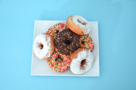 Donut cake with brown grain, there are cactus tree accessories set in light blueの写真素材