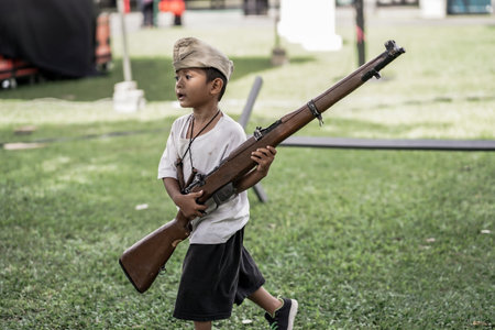 theatrical war general attack 1 march, using war uniforms and weapons in the Dutch colonial era. They shoot each other. : Yogyakarta, Indonesia - 01 March 2022のeditorial素材