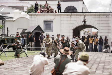 theatrical war general attack 1 march, using war uniforms and weapons in the Dutch colonial era. They shoot each other. : Yogyakarta, Indonesia - 01 March 2022のeditorial素材