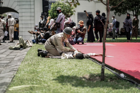 theatrical war general attack 1 march, using war uniforms and weapons in the Dutch colonial era. They shoot each other. : Yogyakarta, Indonesia - 01 March 2022のeditorial素材