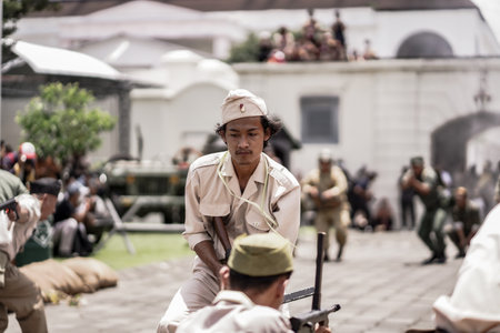 theatrical war general attack 1 march, using war uniforms and weapons in the Dutch colonial era. They shoot each other. : Yogyakarta, Indonesia - 01 March 2022のeditorial素材