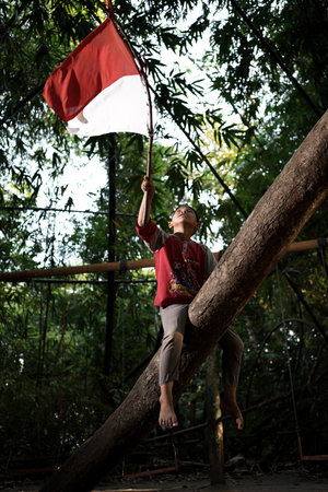 Concept photo of village children who are excited and play in the Indonesian independence edition carrying the flag. : Bantul, Indonesia - 15 August 2021のeditorial素材