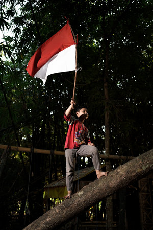Concept photo of village children who are excited and play in the Indonesian independence edition carrying the flag. : Bantul, Indonesia - 15 August 2021のeditorial素材