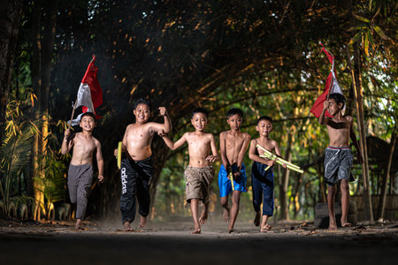 Concept photo of village children who are excited and play in the Indonesian independence edition carrying the flag. : Bantul, Indonesia - 15 August 2021のeditorial素材