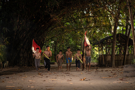 Concept photo of village children who are excited and play in the Indonesian independence edition carrying the flag. : Bantul, Indonesia - 15 August 2021のeditorial素材