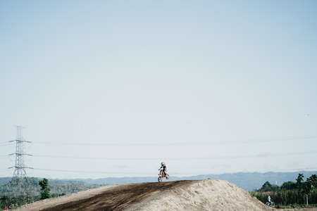 A scene of a motocross rider jumping beautifully during practice at the Sultan Agung circuit. : Bantul, Indonesia - 11 August 2021のeditorial素材