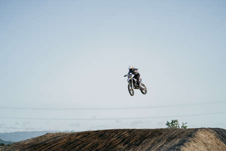 A scene of a motocross rider jumping beautifully during practice at the Sultan Agung circuit. : Bantul, Indonesia - 11 August 2021のeditorial素材