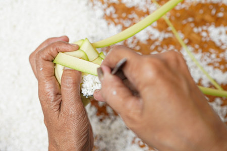 The process of making ketupat is a traditional food during Eid. Put the rice in the ketupat container.の写真素材