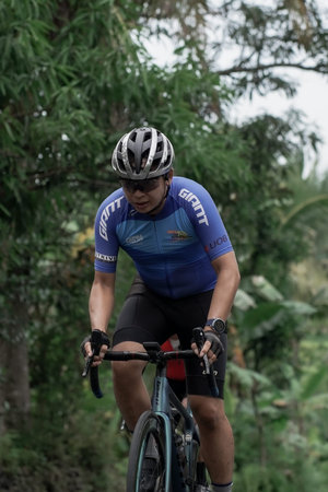 A group of road bike athletes from Mula and Nusantara pro cycling competed on the road, preparing...