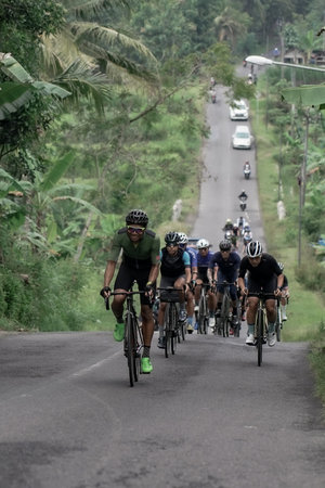 Expression and style of professional road bike cyclists through the uphill route, preparing for the...