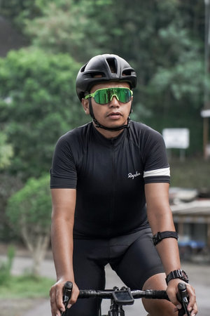 A group of road bike athletes from Mula and Nusantara pro cycling competed on the road, preparing...