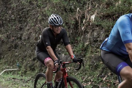 A group of road bike athletes from Mula and Nusantara pro cycling competed on the road, preparing for a test route for the Tour de ambarrukmo 2022. : Sleman, Indonesia - 21 May 2022のeditorial素材