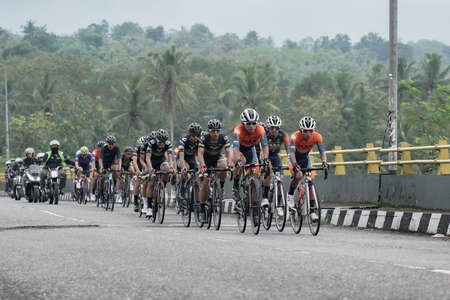 A group of road bike athletes from Mula and Nusantara pro cycling competed on the road, preparing for a test route for the Tour de ambarrukmo 2022. : Sleman, Indonesia - 21 May 2022のeditorial素材