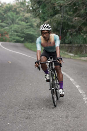 Expression and style of professional road bike cyclists through the uphill route, preparing for the test route for the Tour de ambarrukmo 2022. : Sleman, Indonesia - 21 May 2022のeditorial素材