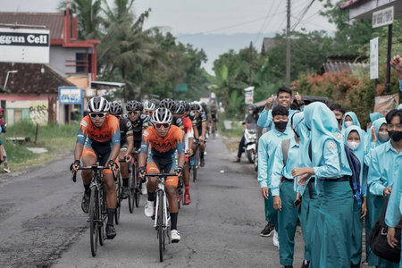 A group of road bike athletes from Mula and Nusantara pro cycling competed on the road, preparing...