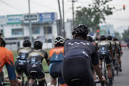 A group of road bike athletes from Mula and Nusantara pro cycling competed on the road, preparing...