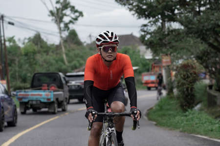 A group of road bike athletes from Mula and Nusantara pro cycling competed on the road, preparing for a test route for the Tour de ambarrukmo 2022. : Sleman, Indonesia - 21 May 2022のeditorial素材