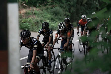 Professional road bike cyclists pass the background scenery of Prambanan temple, preparing for the test route for the Tour de ambarrukmo 2022. : Sleman, Indonesia - 21 May 2022のeditorial素材