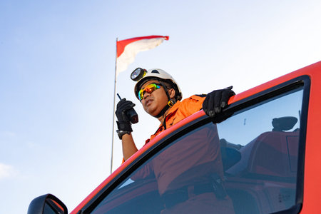 A Basarnas rescue team standing guard at the car door and carrying Handy Talky. : Yogayakarta,...