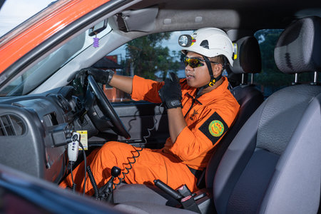 A Basarnas rescue team standing guard at the car door and carrying Handy Talky. : Yogayakarta,...