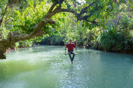 The maron river in Pacitan Indonesia is a travel destination on the river where there is a swing for taking pictures.の写真素材