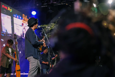 Music Festival. The performance of Jikustik, a band from Yogyakarta. The audience cheers and enjoys the music. : Yogyakarta, Indonesia - 07 September 2022のeditorial素材