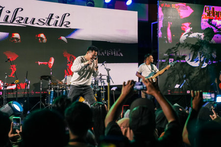 Music Festival. The performance of Jikustik, a band from Yogyakarta. The audience cheers and enjoys the music. : Yogyakarta, Indonesia - 07 September 2022のeditorial素材