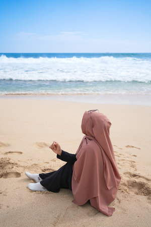 tourists enjoy a quiet and beautiful beach on the beach of Watu Lumbung, Gunung Kidul area.の写真素材