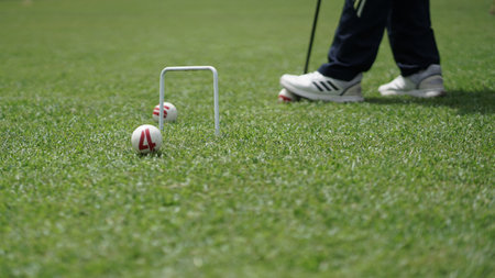 The gateball player's feet and their tools on the grass field.の写真素材