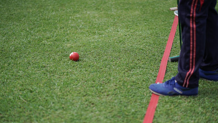 The gateball player's feet and their tools on the grass field.の写真素材