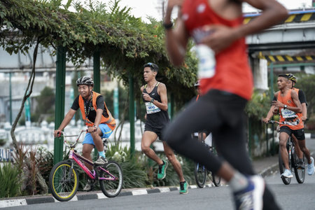 Yogyakarta, Indonesia - October 30, 2022 : running participants who pass through the streets of the city of Yogyakarta, they take part in the "Klik Dokter Run Fest 2022" running competition.のeditorial素材