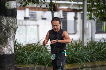 Yogyakarta, Indonesia - October 30, 2022 : running participants who pass through the streets of the city of Yogyakarta, they take part in the "Klik Dokter Run Fest 2022" running competition.のeditorial素材