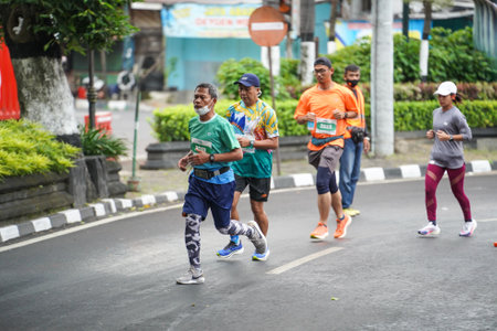 Yogyakarta, Indonesia - October 30, 2022 : running participants who pass through the streets of the city of Yogyakarta, they take part in the "Klik Dokter Run Fest 2022" running competition.のeditorial素材
