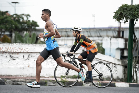 Yogyakarta, Indonesia - October 30, 2022 : running participants who pass through the streets of the city of Yogyakarta, they take part in the "Klik Dokter Run Fest 2022" running competition.のeditorial素材