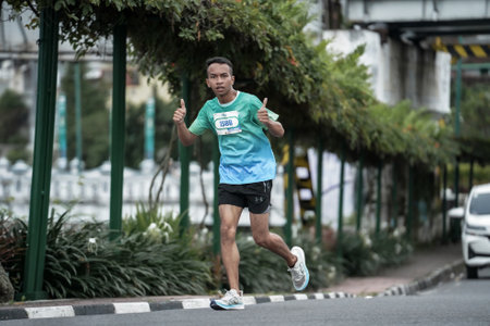 Yogyakarta, Indonesia - October 30, 2022 : running participants who pass through the streets of the city of Yogyakarta, they take part in the "Klik Dokter Run Fest 2022" running competition.のeditorial素材
